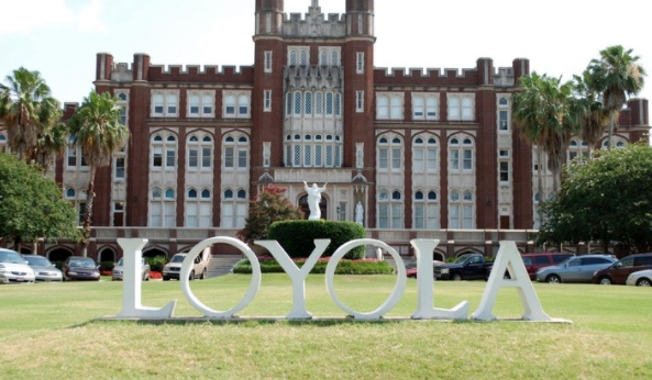 Front of Loyola's campus. Loyola sign and "Touchdown Jesus" in background.