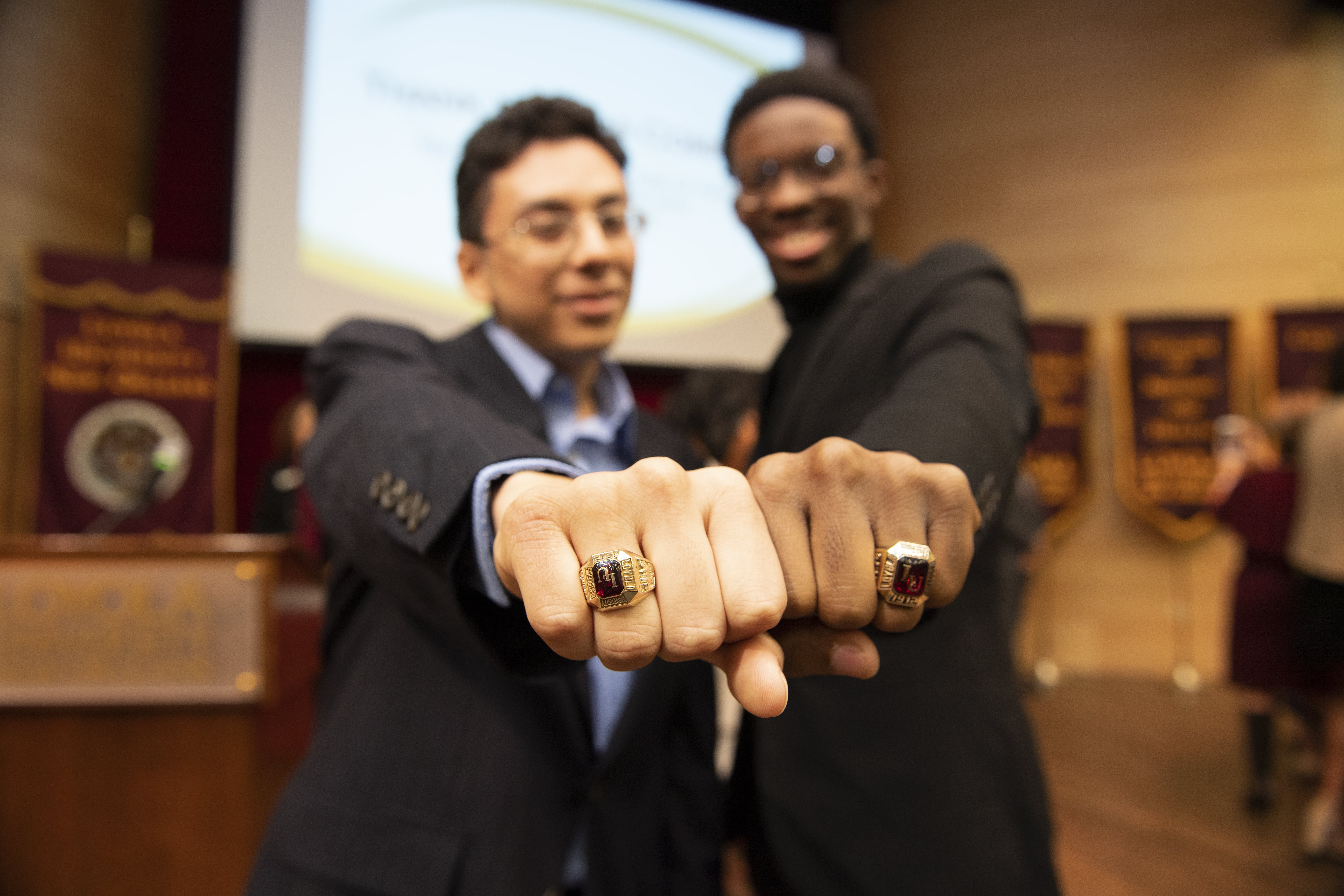 2 people showing their rings