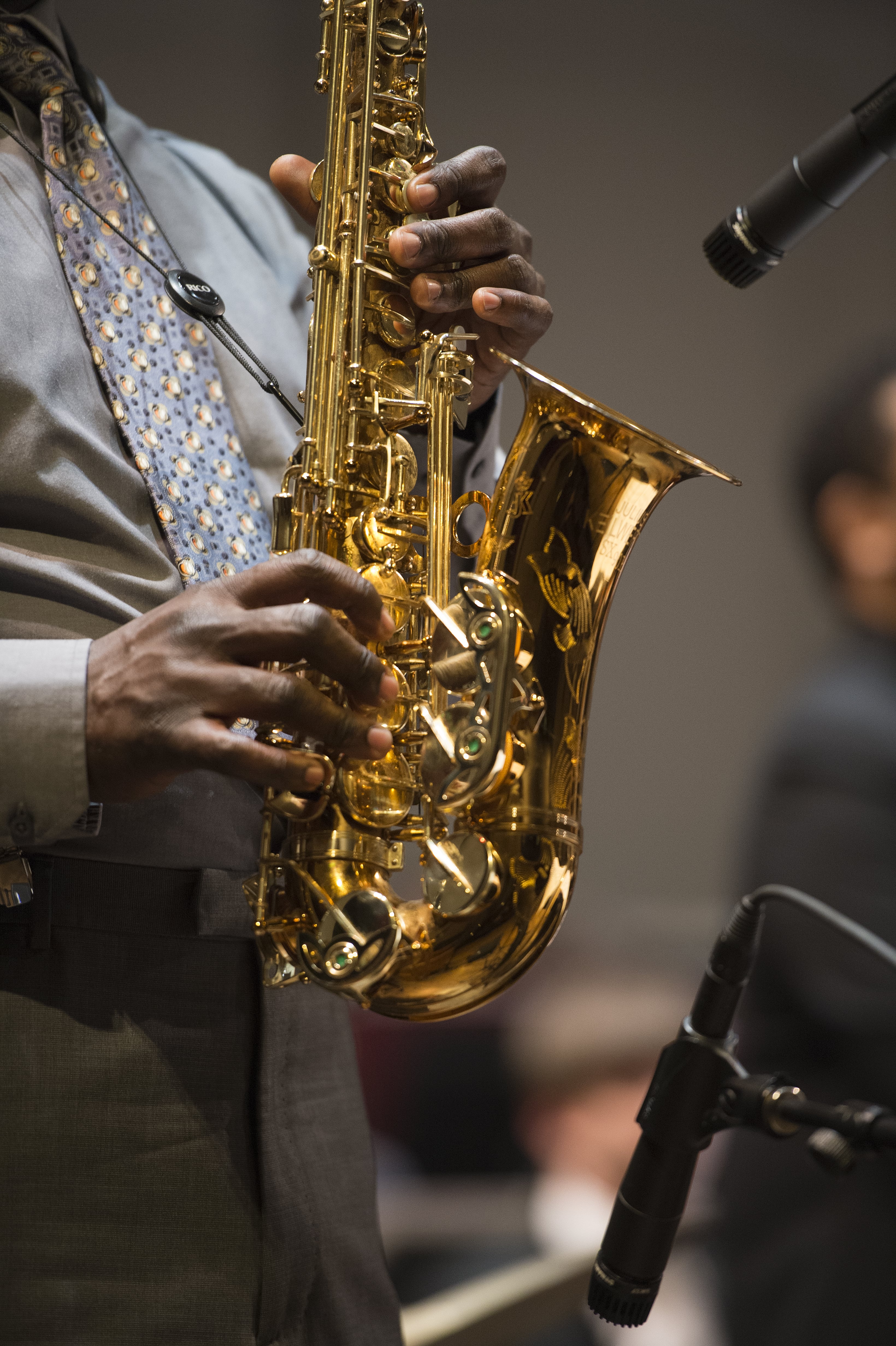 A close-up photo of a musician playing saxophone.