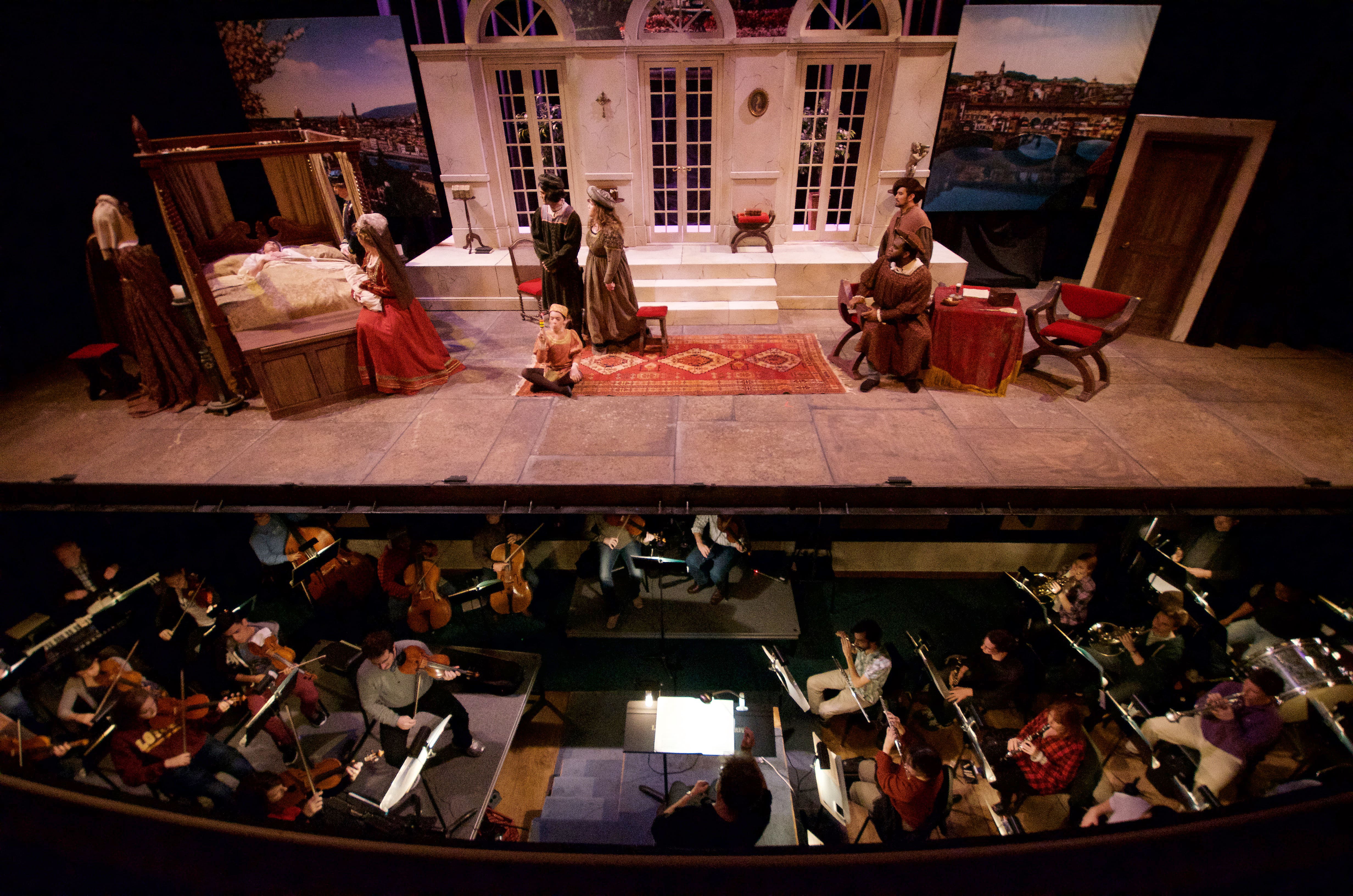 A photo of a previous Loyola Opera production, with a view of the pit orchestra and performers on stage.
