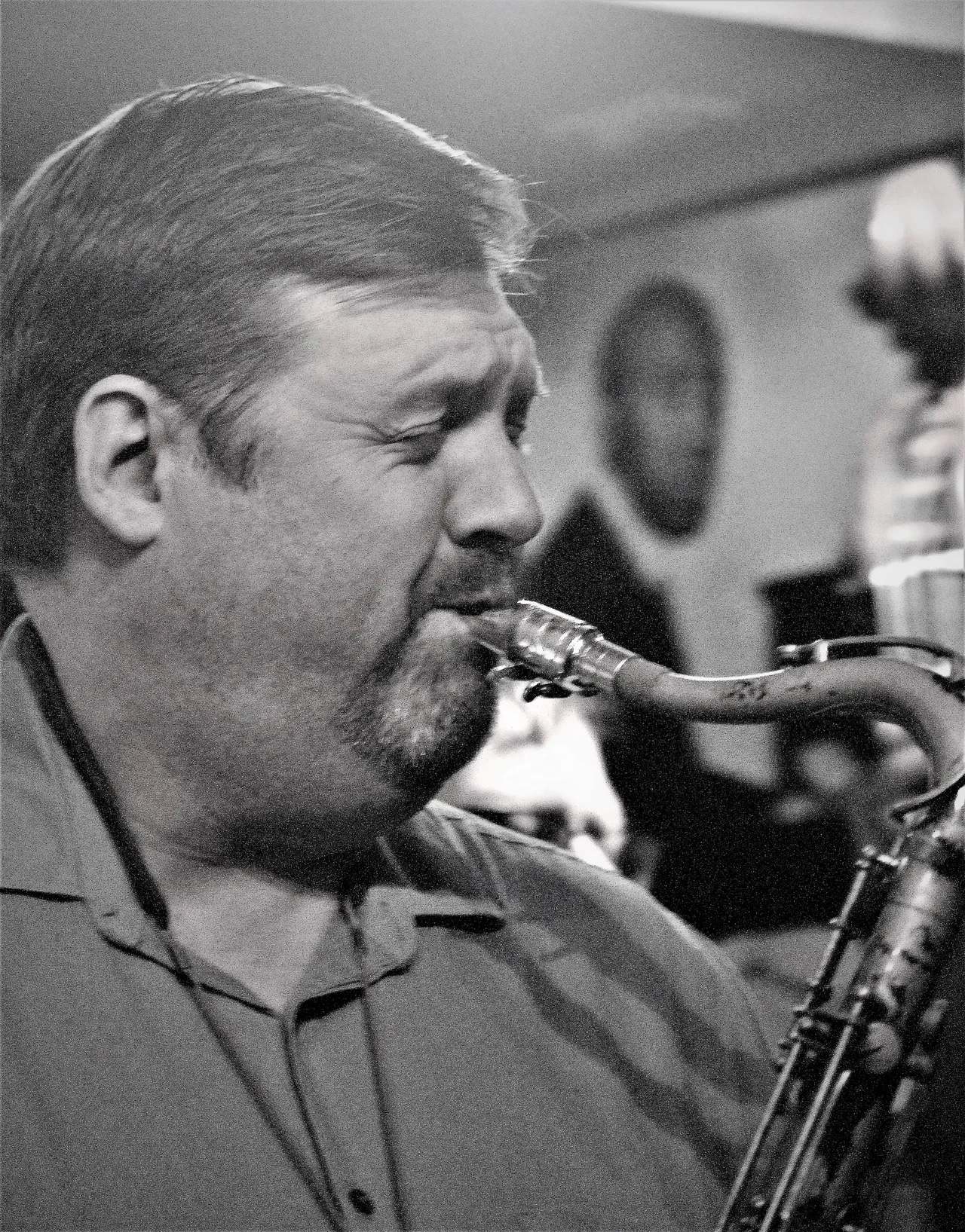 A black and white photo playing tenor saxophone.