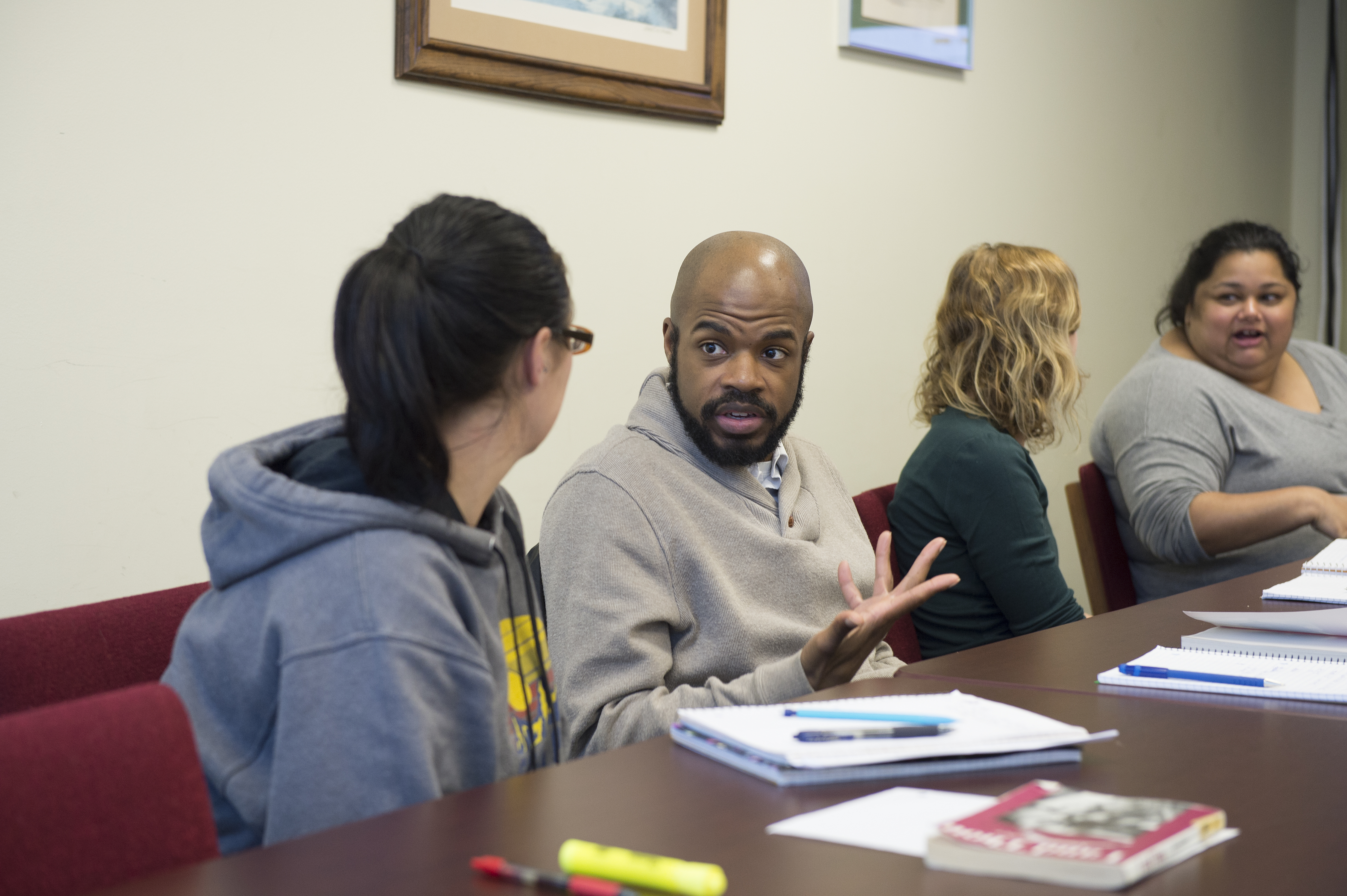 A group of Loyola Online students in discussing an assignment