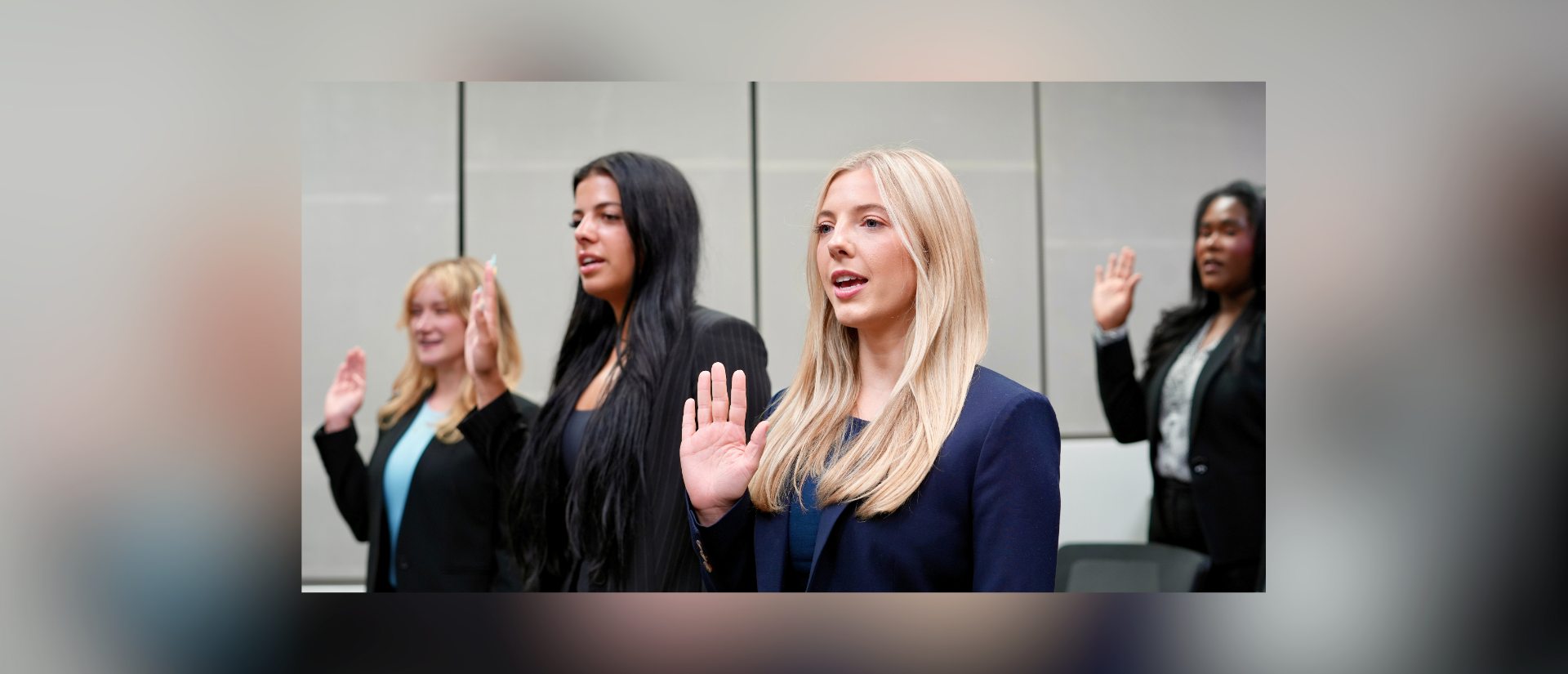 Student raise their hands to be sworn in to practice law.